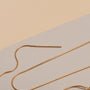 "Charms Bracelet": Elegant gold charms bracelet with a minimalist design.