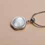 "Charms Bracelet", a silver charm bracelet featuring a sleek, modern pendant design.