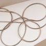 "Charms Bracelet", a sleek silver bracelet with a minimalistic charm design.