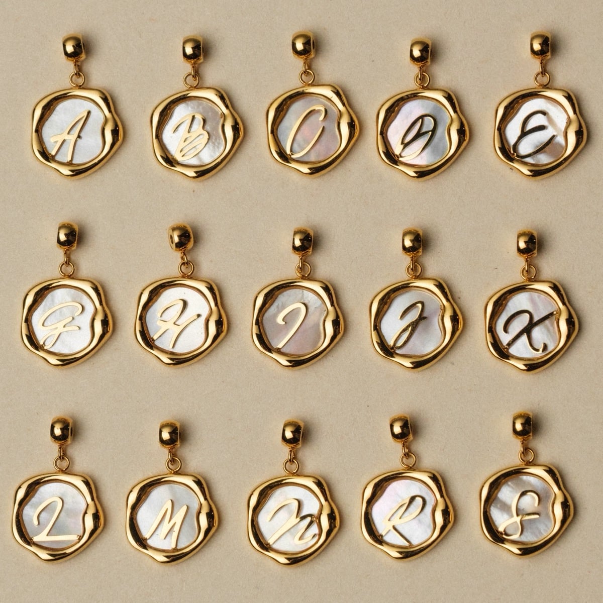 "Letter Charm A-Z", letter charm jewelry in nacre and gold with elegant style.