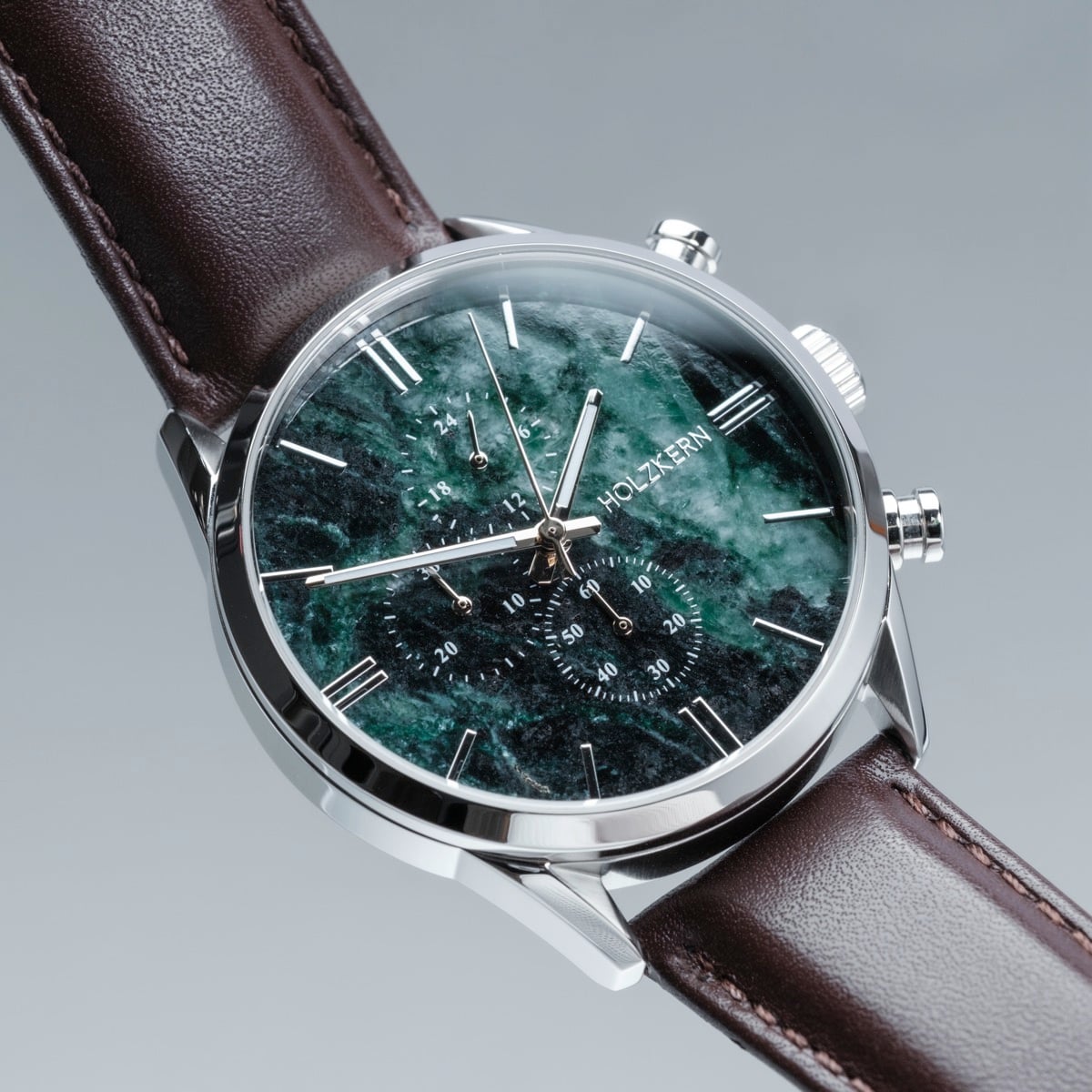 "Gifted" watch featuring a green marble face and dark brown leather strap for a sophisticated look.