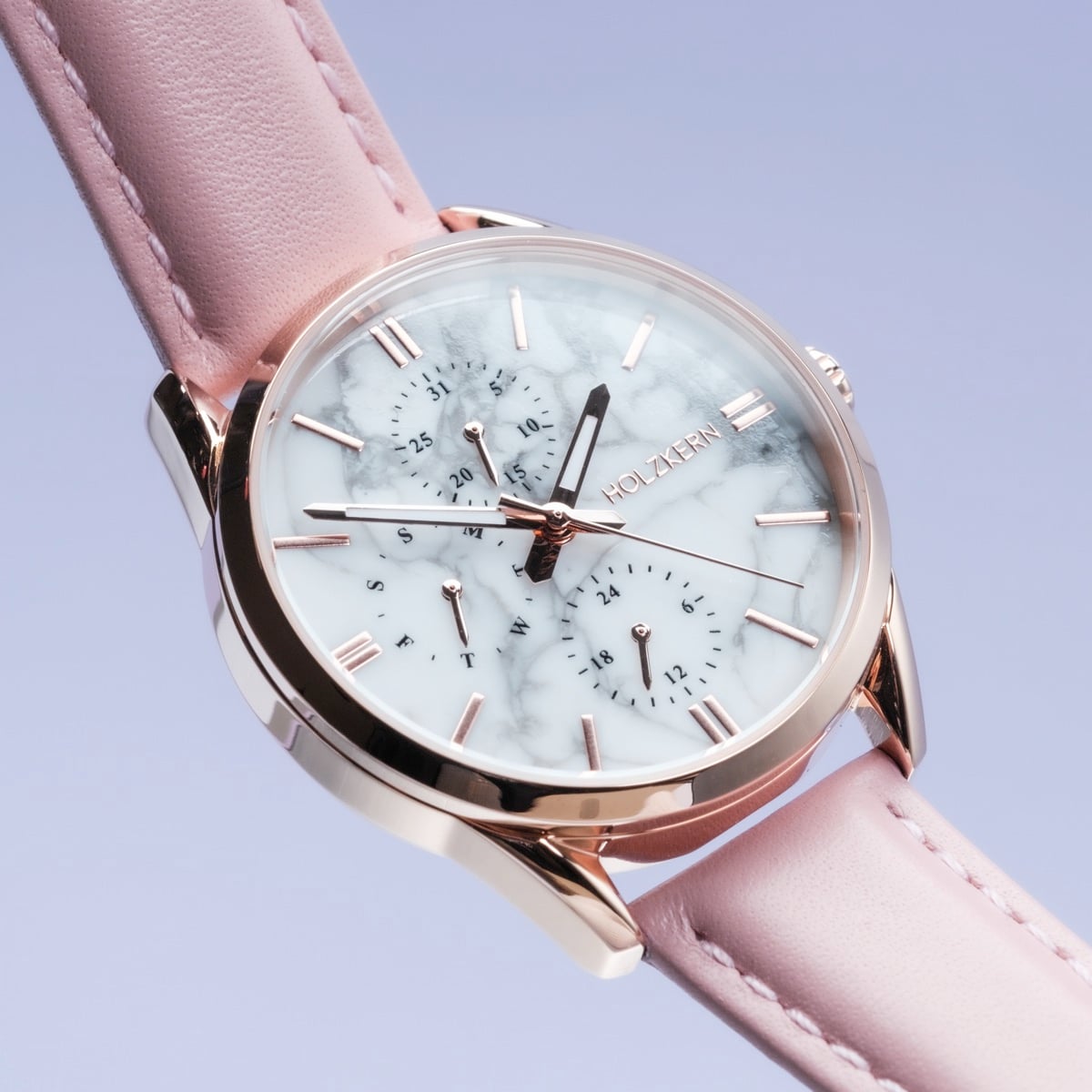 "Gifted" watch with a howlite face and pink leather strap, featuring a sleek, elegant design.