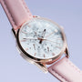 "Gifted" watch with a howlite face and pink leather strap, featuring a sleek, elegant design.