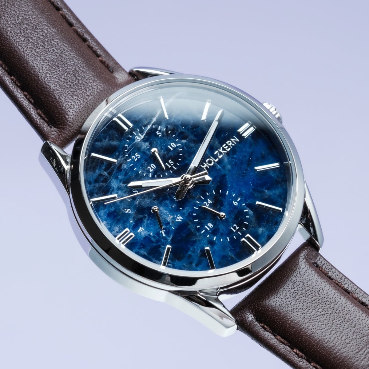 "Gifted" watch featuring a sodalite blue dial and dark brown leather strap with a sleek design.