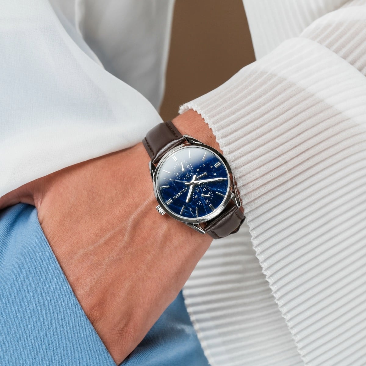 "Gifted" watch with sodalite face and dark brown strap, showcasing an elegant and sophisticated style.