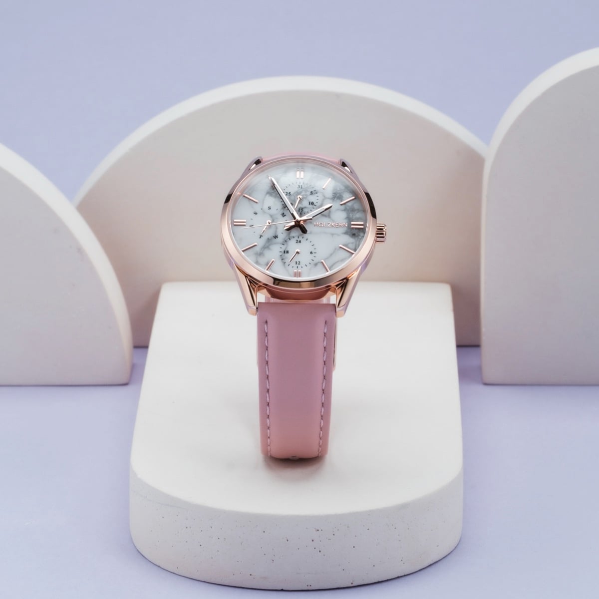 "Gifted" watch featuring a howlite-patterned face and pink strap, elegantly styled against a soft background.