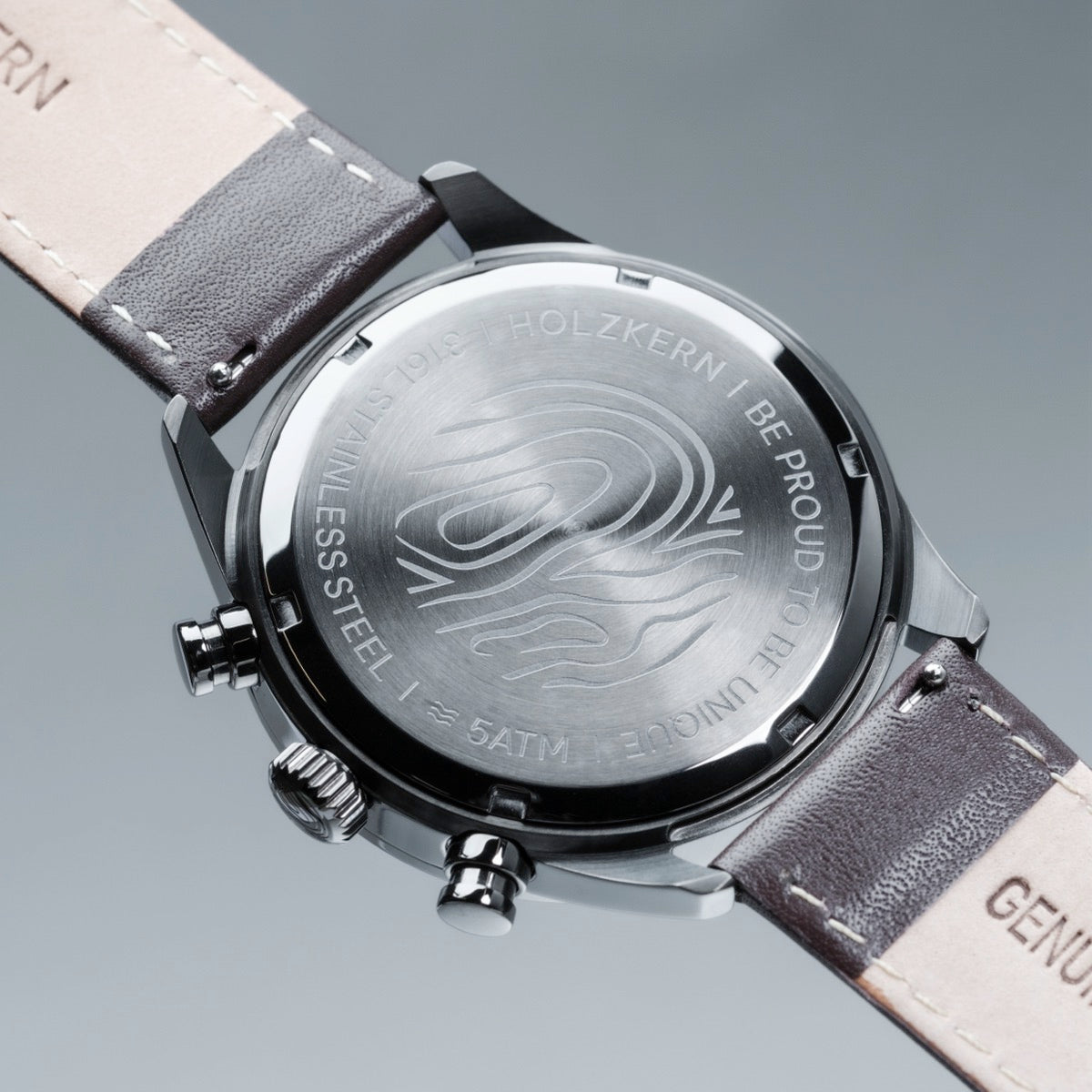 "Gifted" watch featuring a gray marble face and dark brown leather strap for a sleek, modern look.
