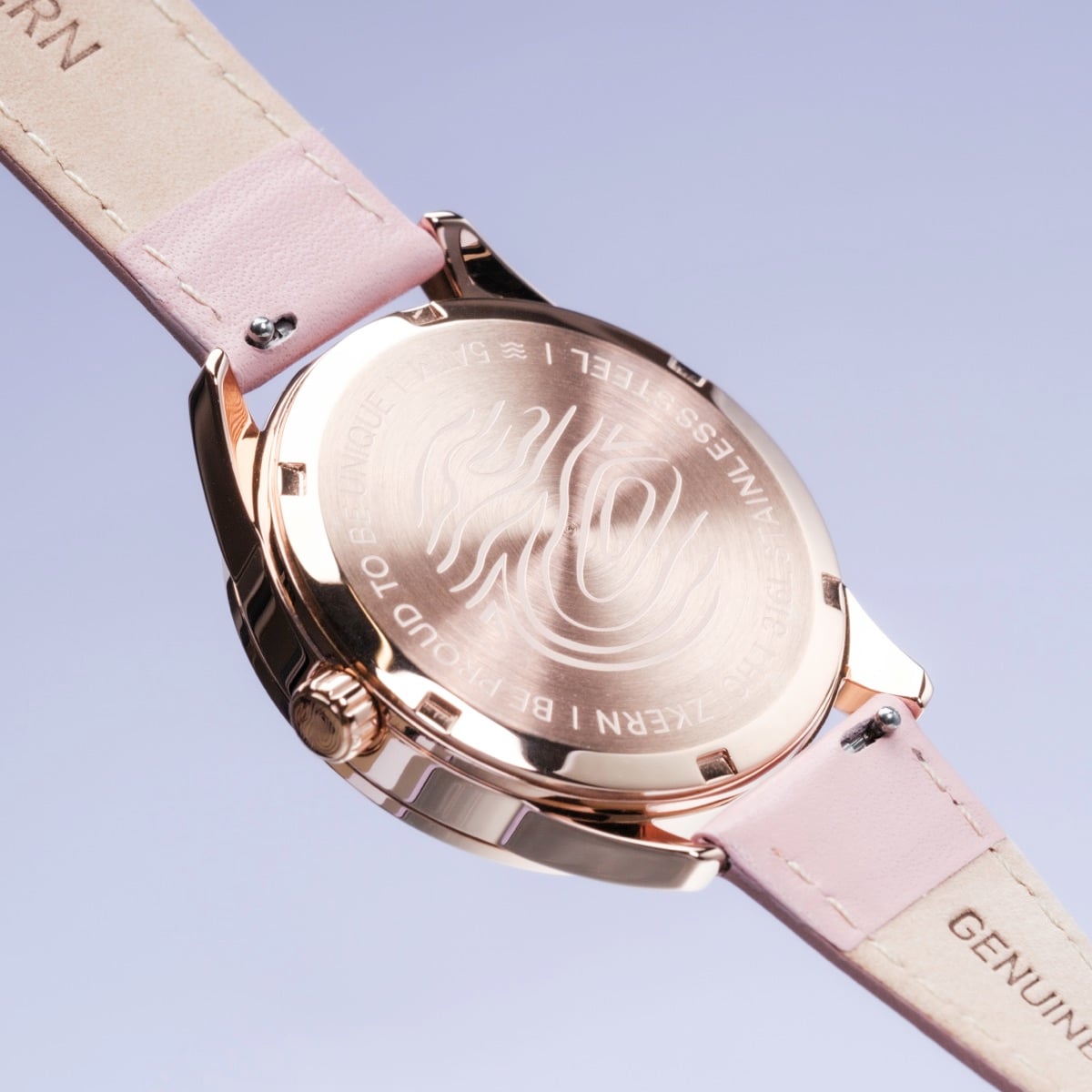 "Gifted" watch featuring a rose gold case and pink strap with an engraved backplate, stylish and elegant design.
