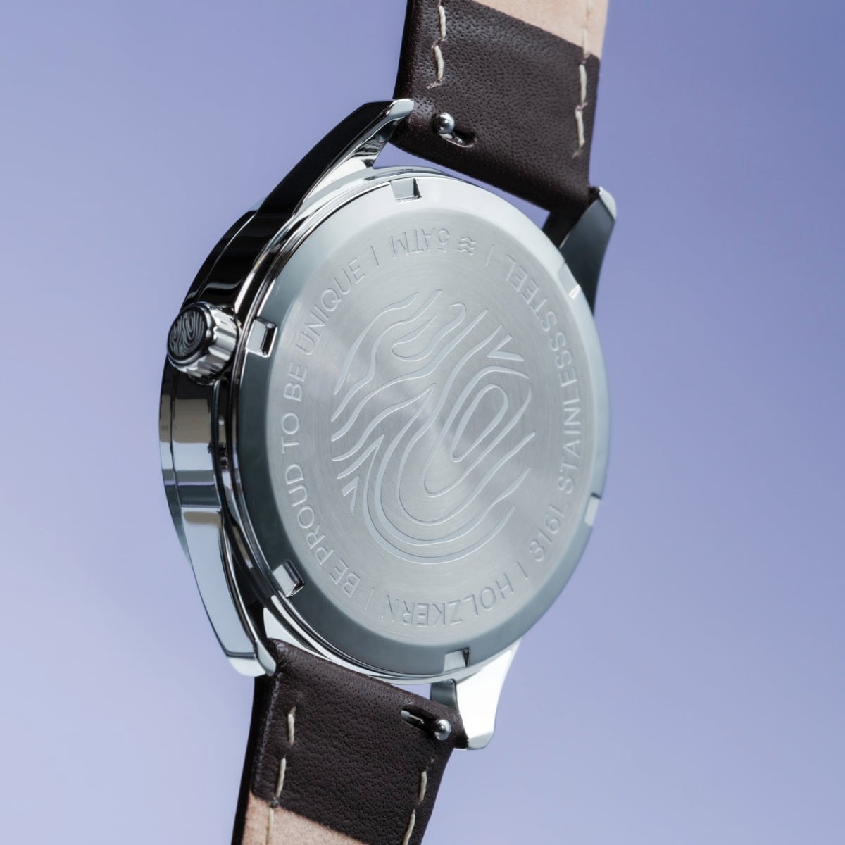 "Gifted" watch with a stainless steel case and dark brown leather strap, featuring a sleek, modern design.