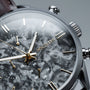 "Gifted" watch featuring a gray marble dial and dark brown strap, blending elegance with modern design.