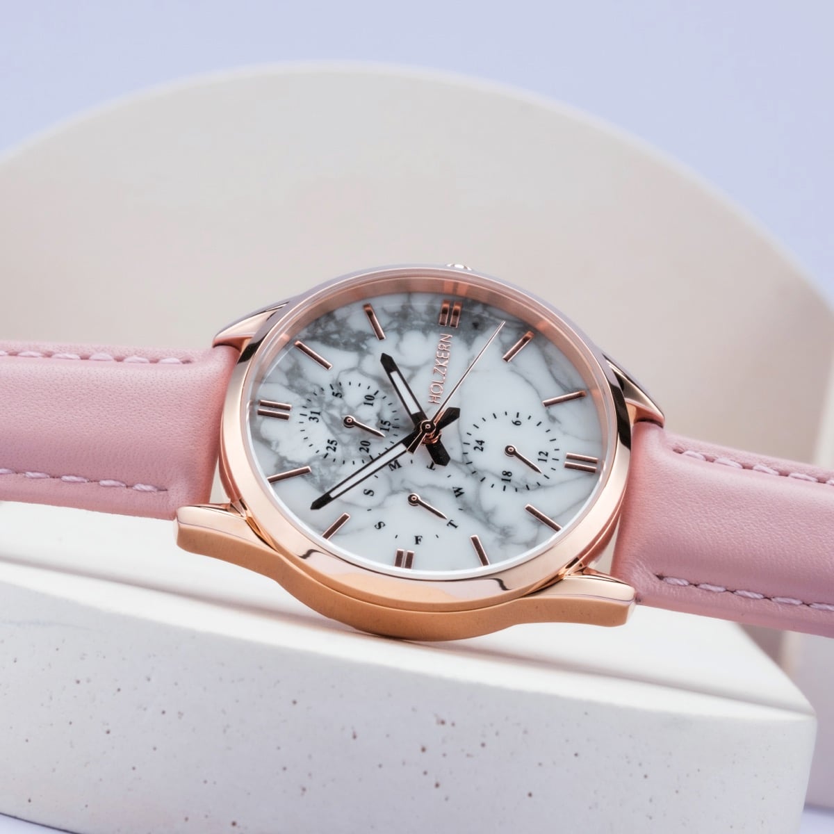 "Gifted" watch featuring a howlite-patterned face and pink leather strap with a rose gold-tone case.