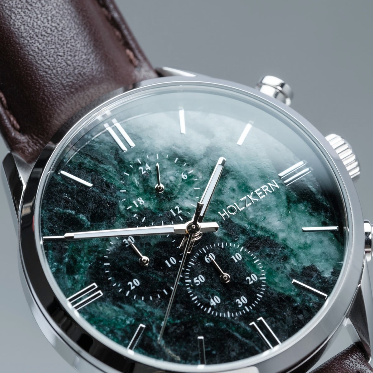 "Gifted" watch features a green marble face with a dark brown leather strap, offering a sophisticated style.