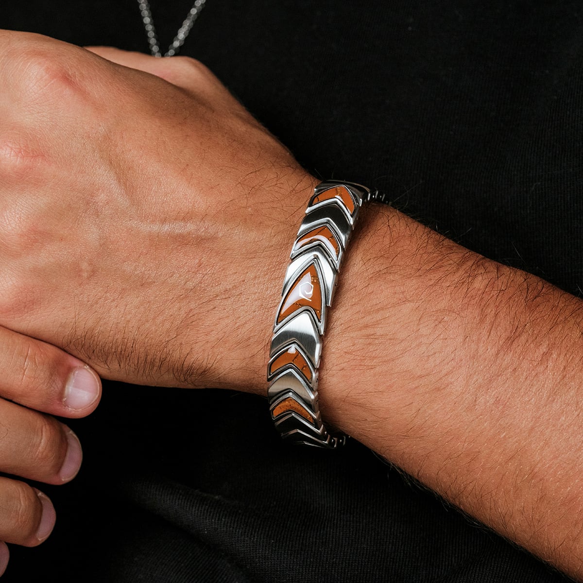 "Operations" bracelet, featuring a zigzag pattern in jasper and silver accents, worn on a wrist.