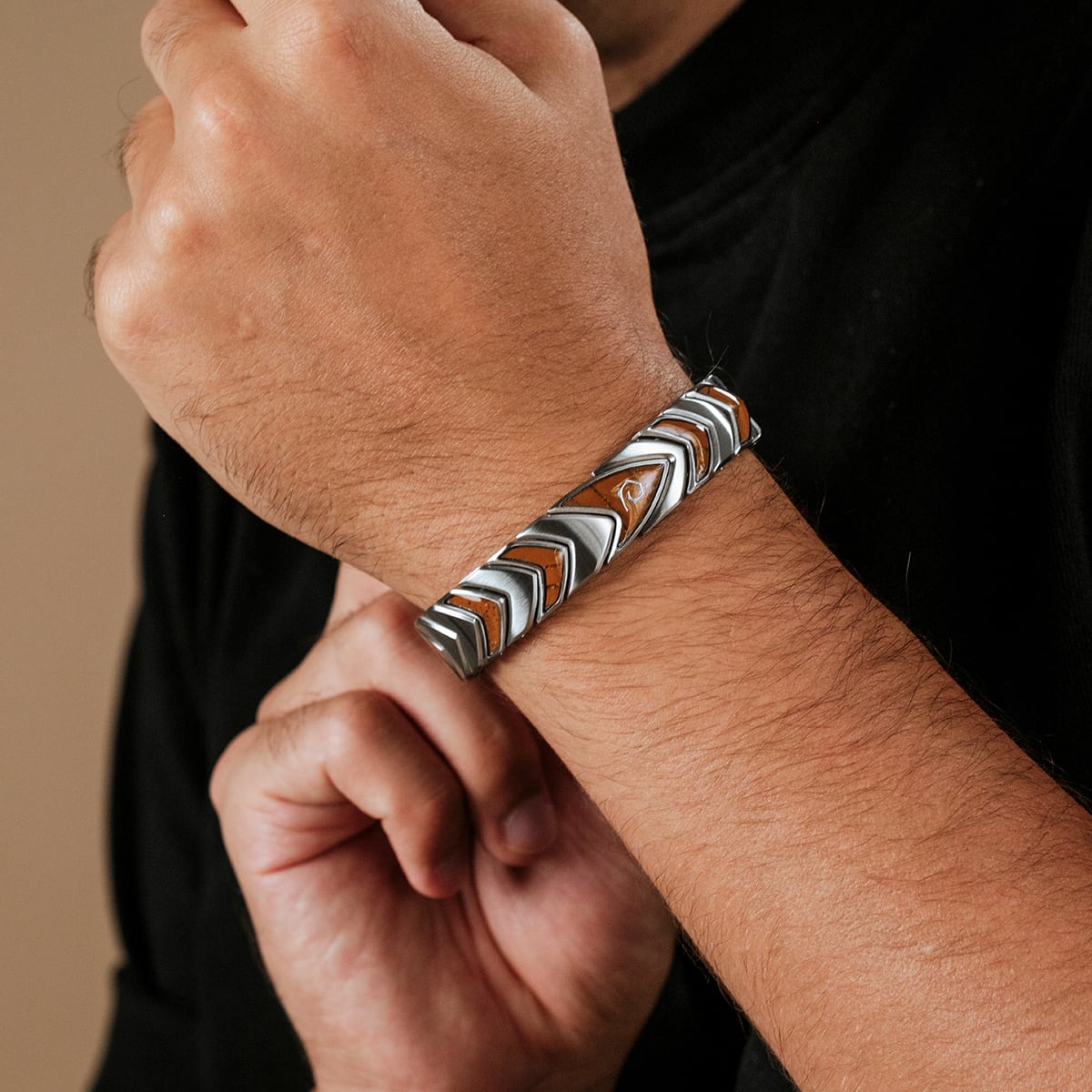 "Operations" bracelet with jasper and silver materials, featuring a bold, zigzag pattern on the wrist.