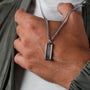 "Interplay Necklace" necklace with gray marble and silver finish, showcasing a sleek rectangular pendant design.