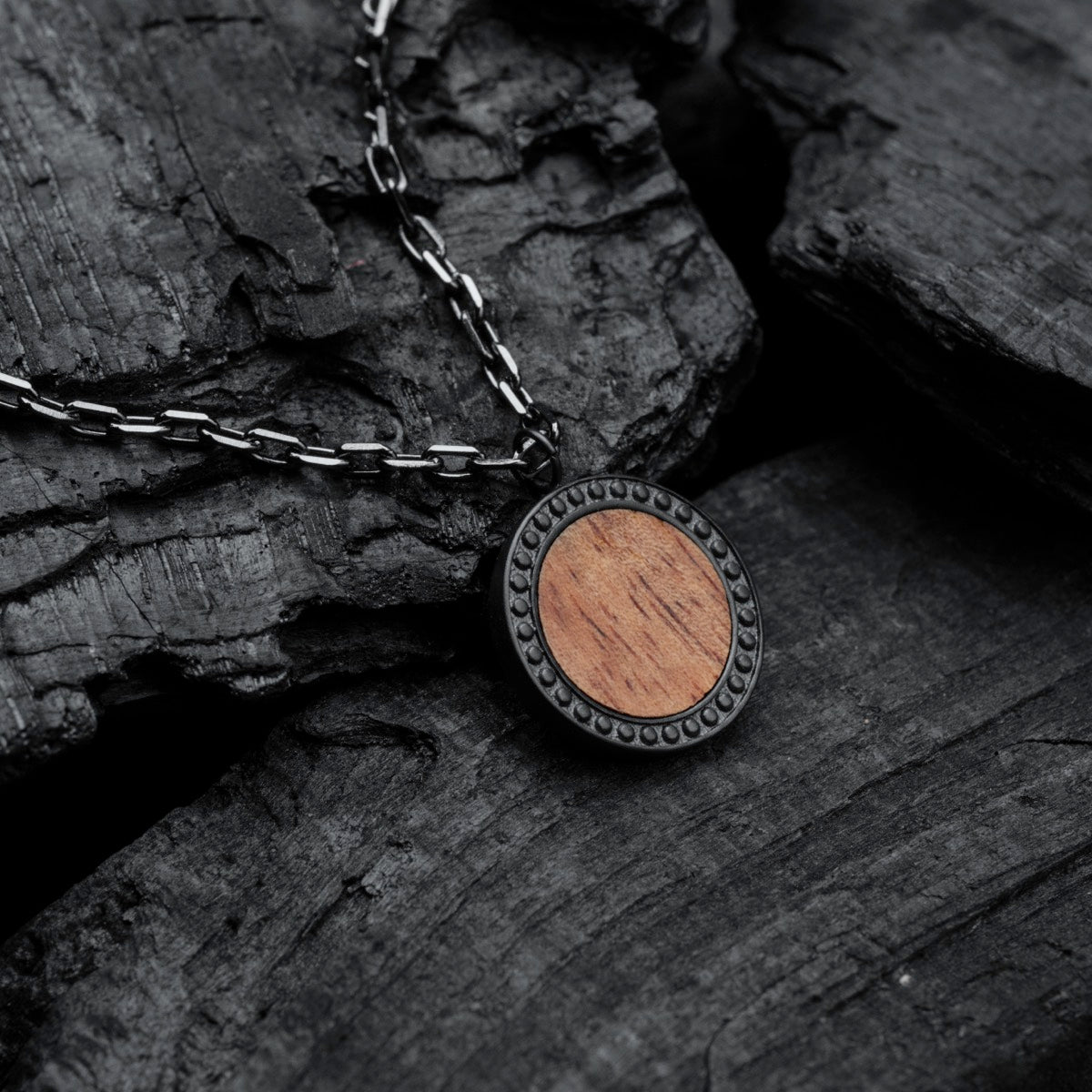 "Interplay Necklace", a stylish necklace featuring Koa wood and gray accents on a textured chain.