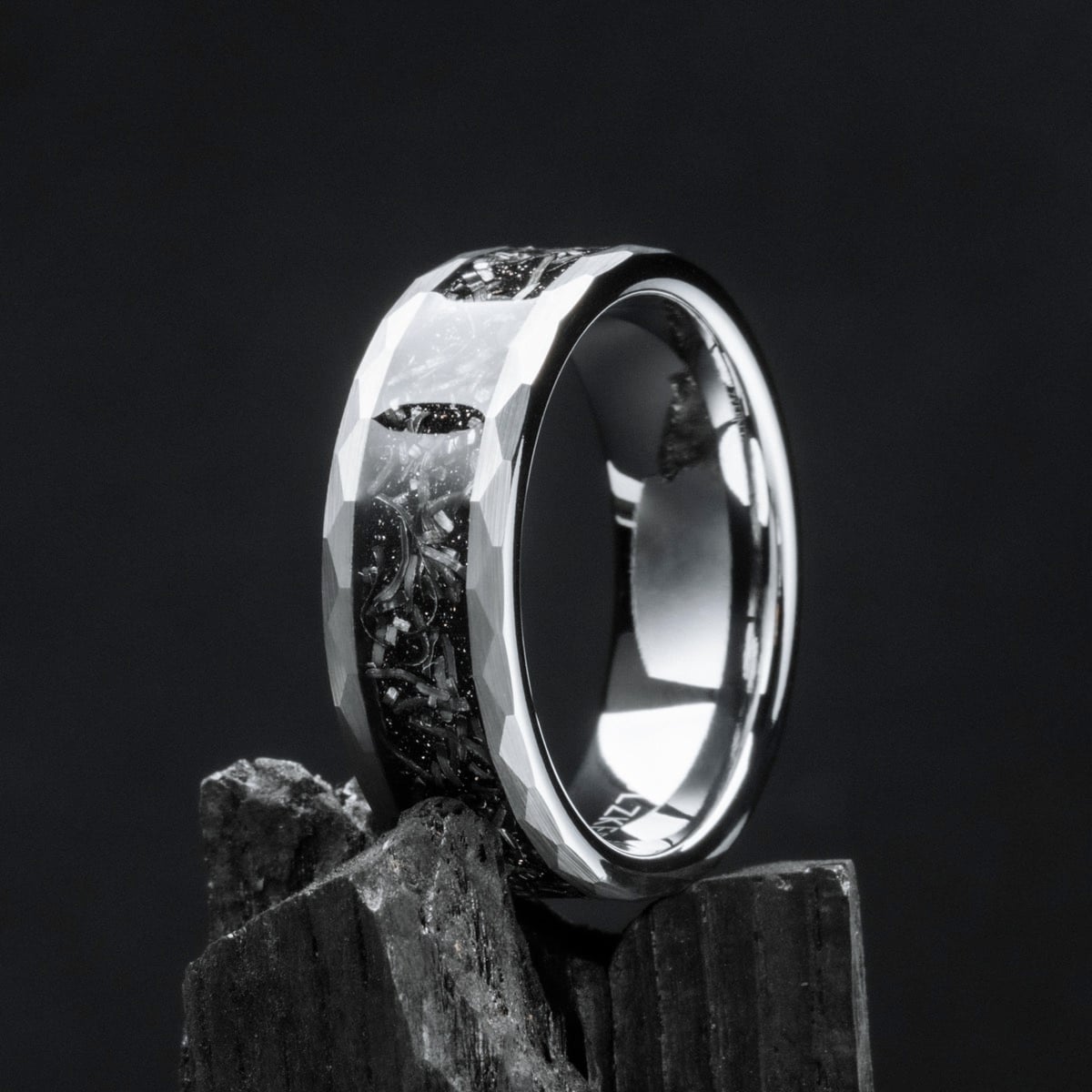 Sumo Ring - A tungsten ring with a meteorite inlay, featuring a faceted, reflective design on a dark background.