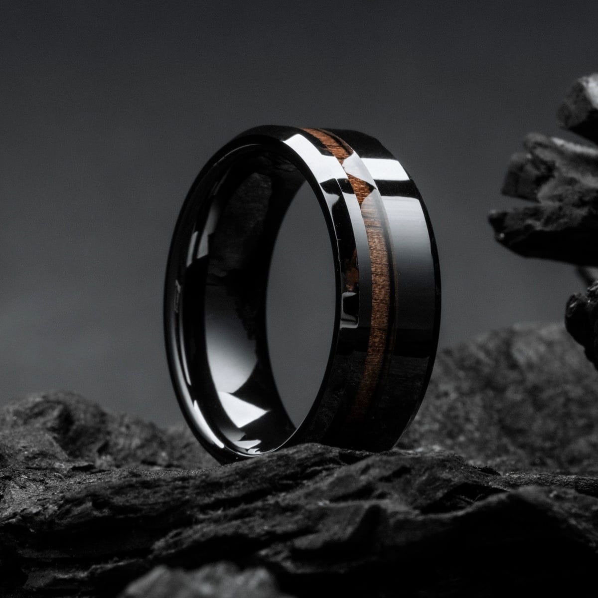 "Sumo Ring", a sleek ring featuring walnut and ceramic, highlighting its modern and sophisticated design.