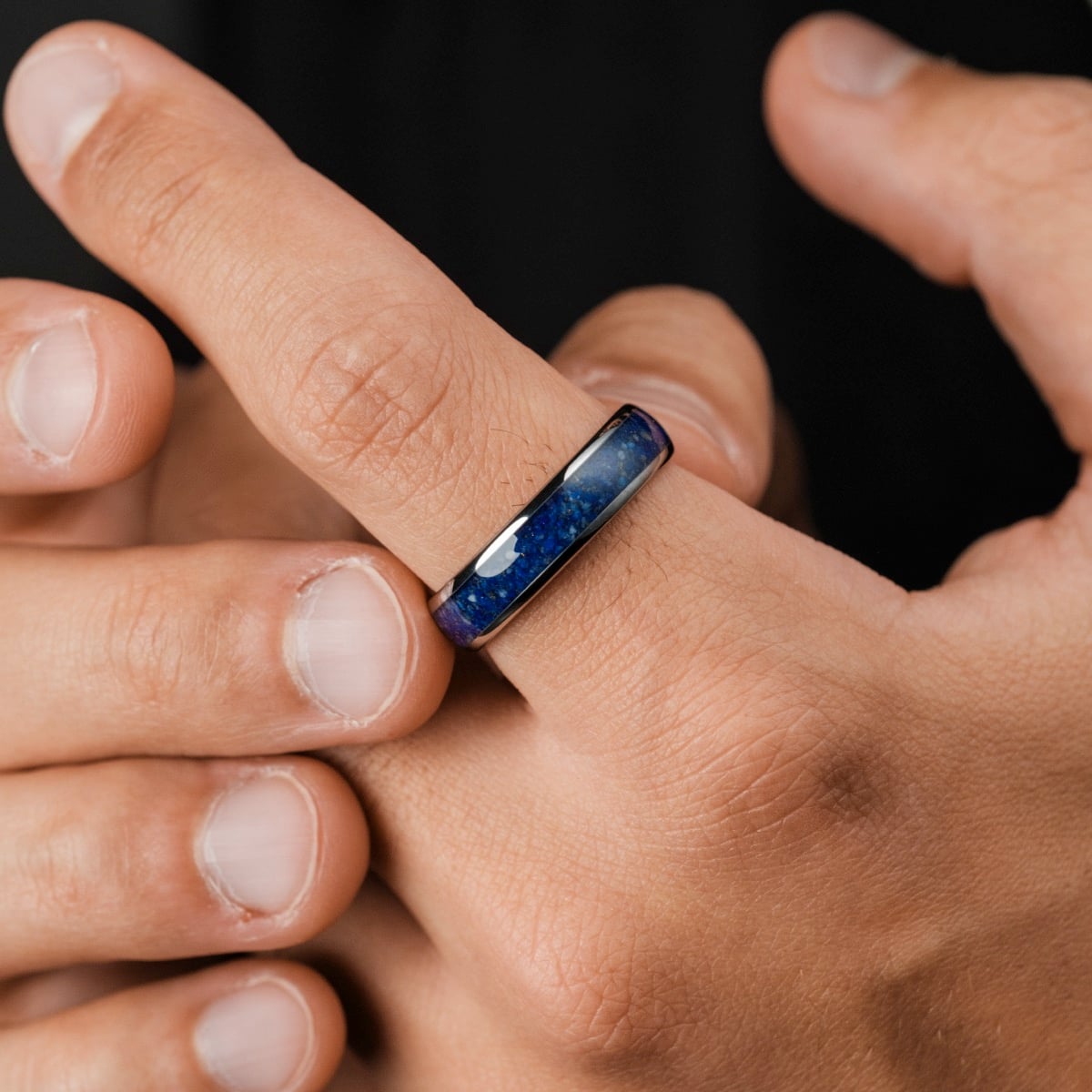 "Sumo Ring" ring with a sleek lapis lazuli inlay and dogsten finish, worn on a hand.