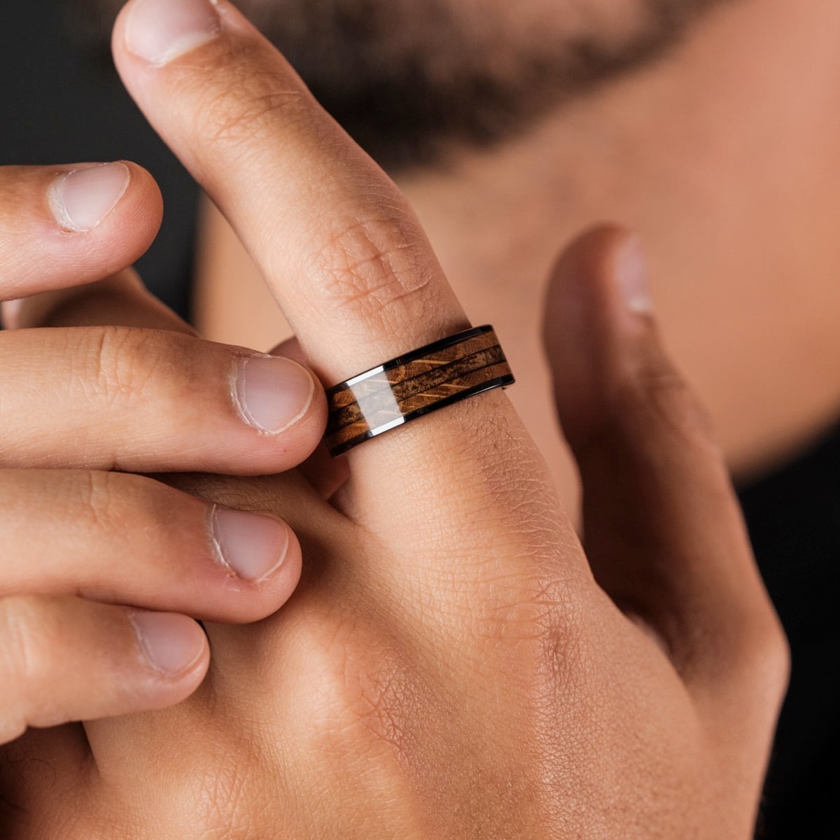 "Sumo Ring", a stylish whiskey wood and ceramic ring with a sleek, modern design.