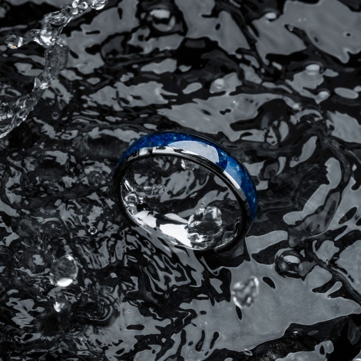"Sumo Ring", a stylish lapis lazuli and tungsten ring, features a sleek, modern design with vivid blue detailing.