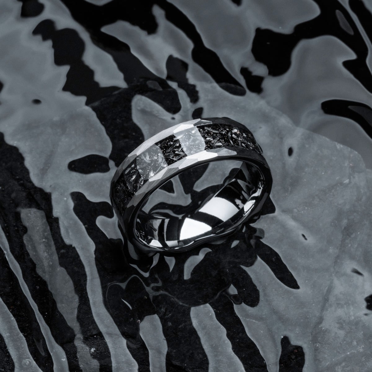 "Sumo Ring" ring, featuring a sleek meteorite and tungsten design on a textured surface.