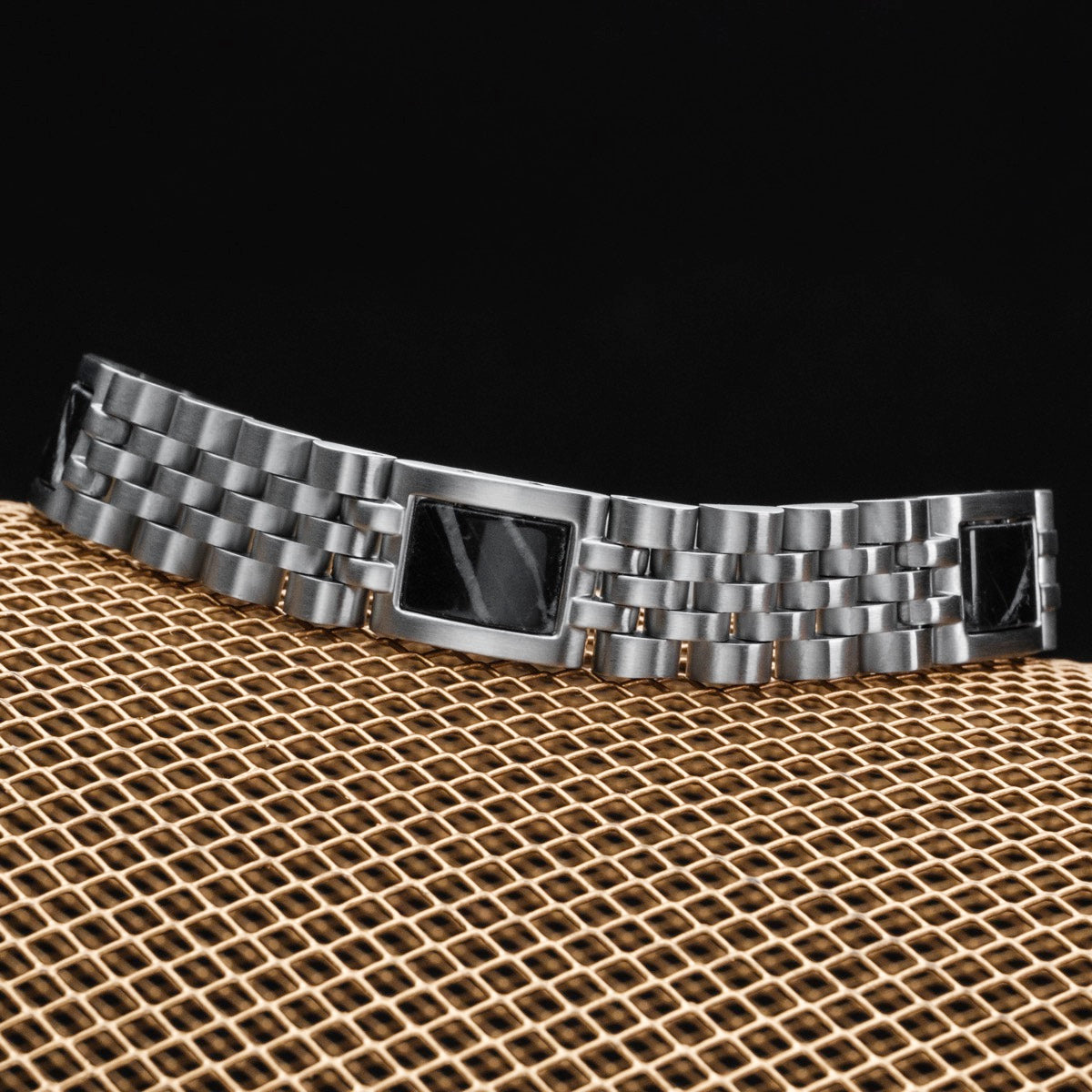 "Pentachord" bracelet, crafted in black marble and silver, showcasing a sleek and modern design.