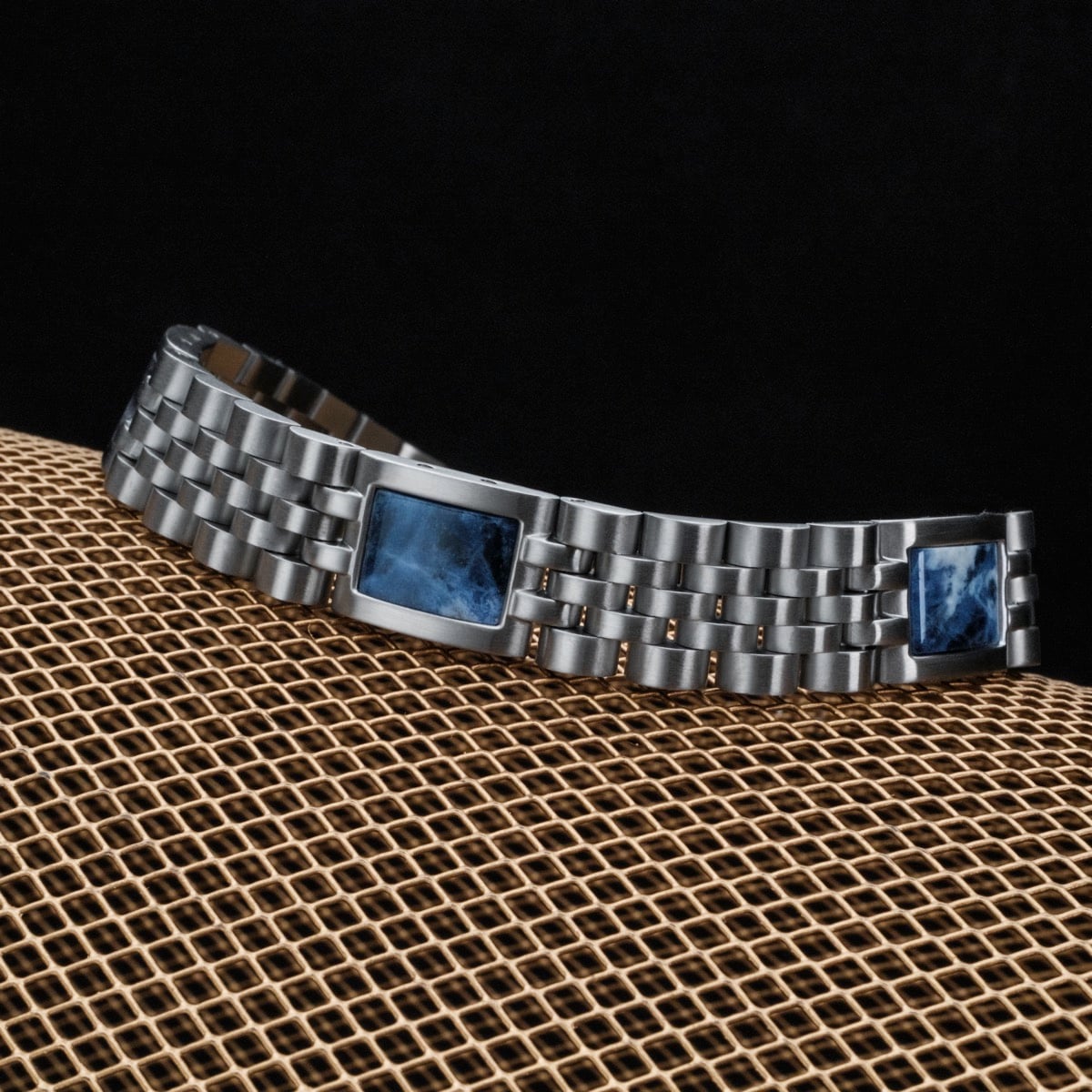 "Pentachord" bracelet, featuring silver links and blue marble accents with a sleek, modern design.