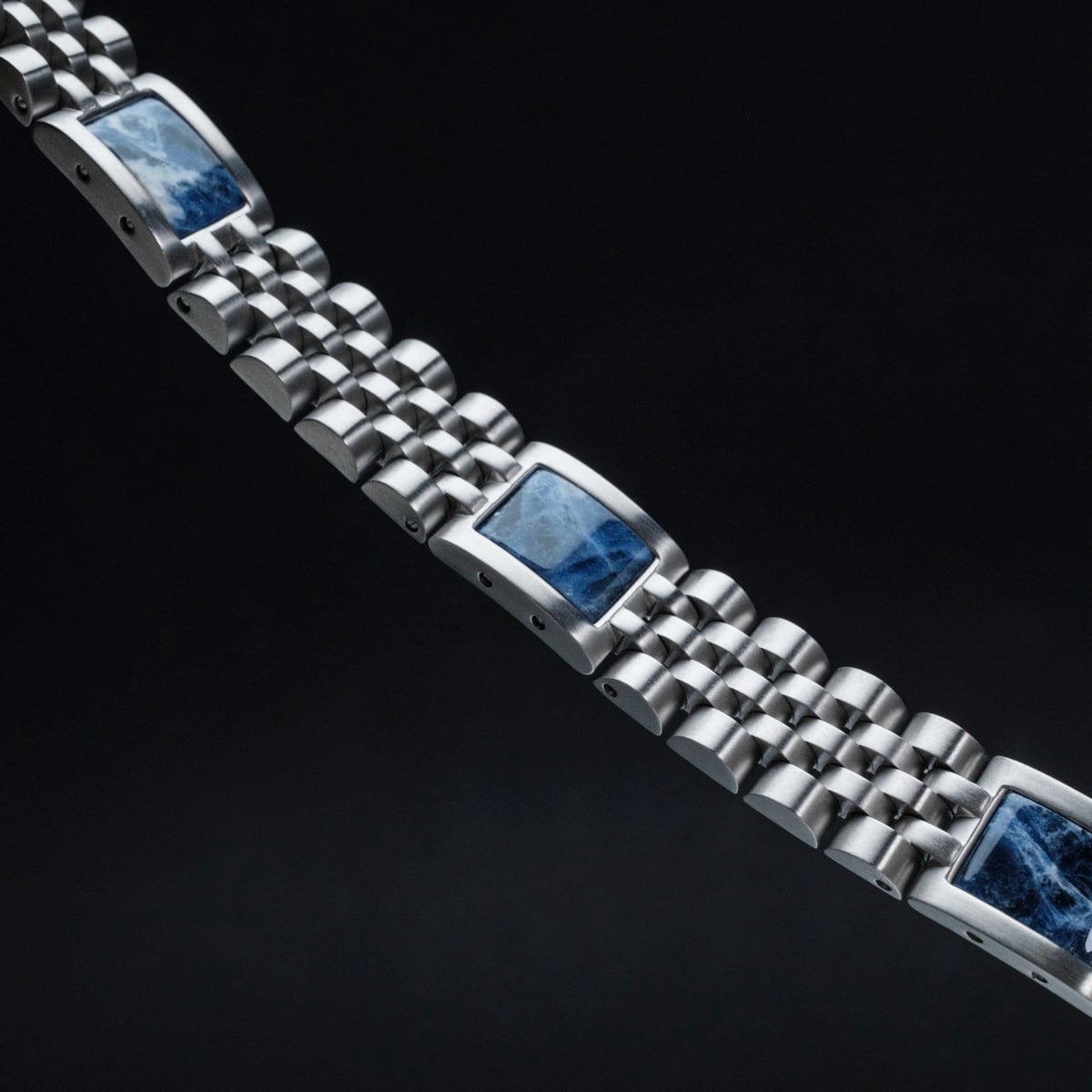 "Pentachord" bracelet featuring a striking blue marble and silver design.