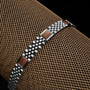 "Pentachord" bracelet, crafted with koa wood and silver, featuring a sleek and elegant design.