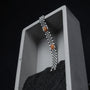 "Pentachord", a stylish bracelet featuring a Koa and Silver design, elegantly displayed on a minimalist background.