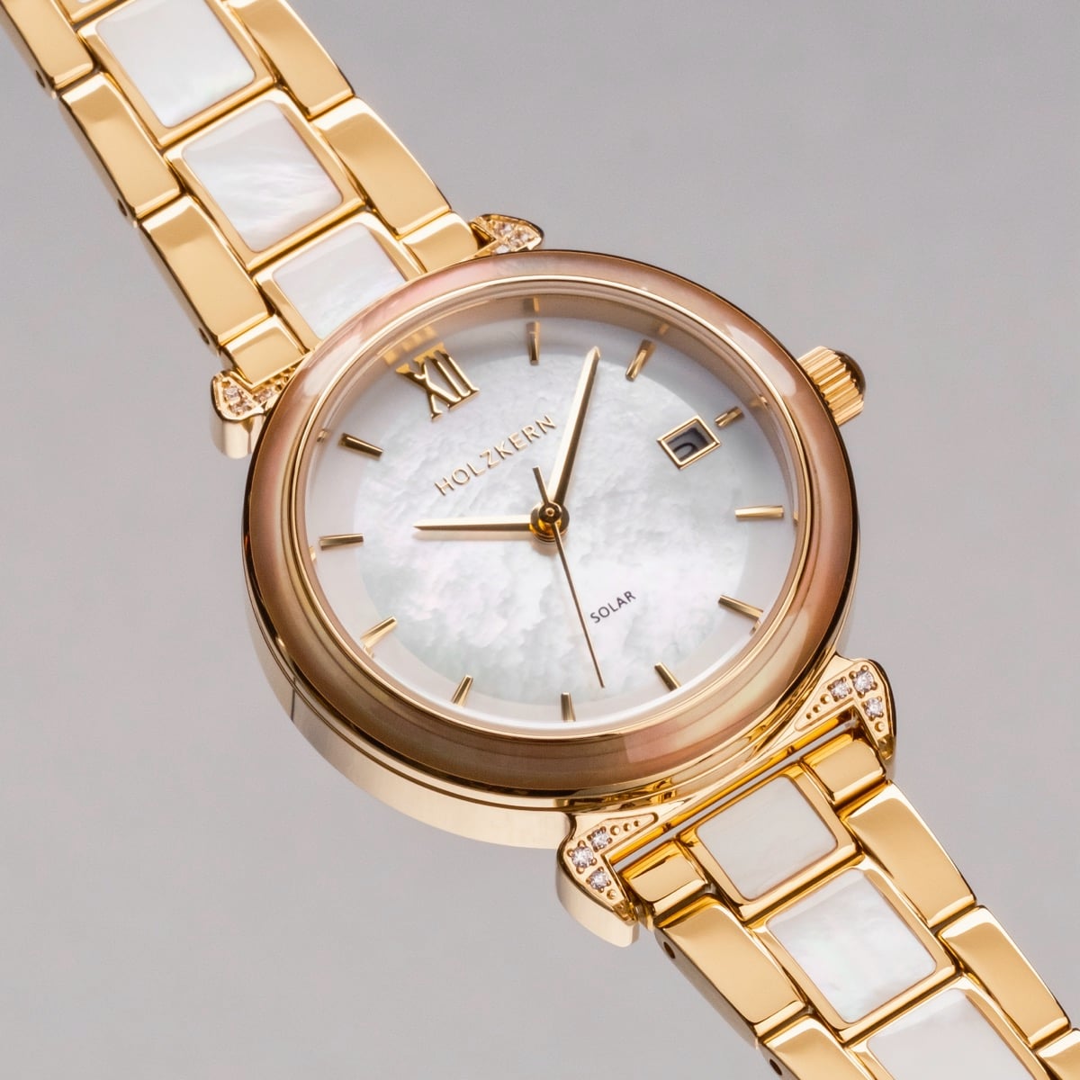"Sunglister" watch, featuring a white mother-of-pearl dial and gold accents, offering a luxurious and elegant style.