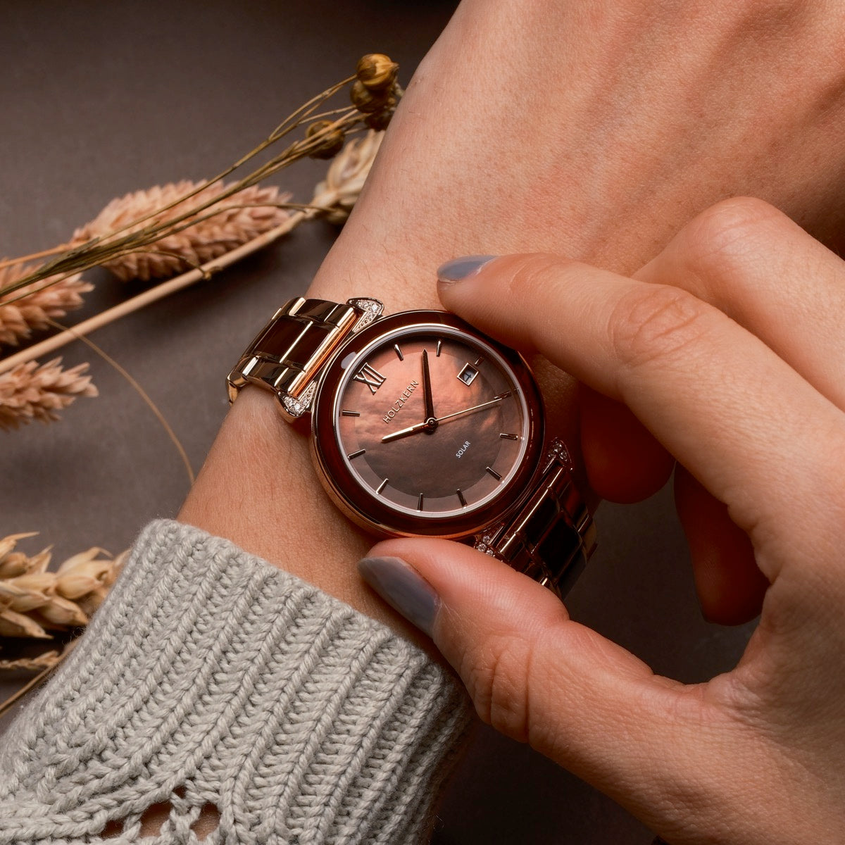 "Sunglister" watch featuring a brown mother-of-pearl face and rose gold accents, exuding elegance and style.