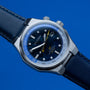 "GMT Cloudhopper" wristwatch features a marble and blue dial with a sleek, modern design.