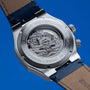"GMT Cloudhopper" watch with stainless steel back, marble accents, and blue leather strap.