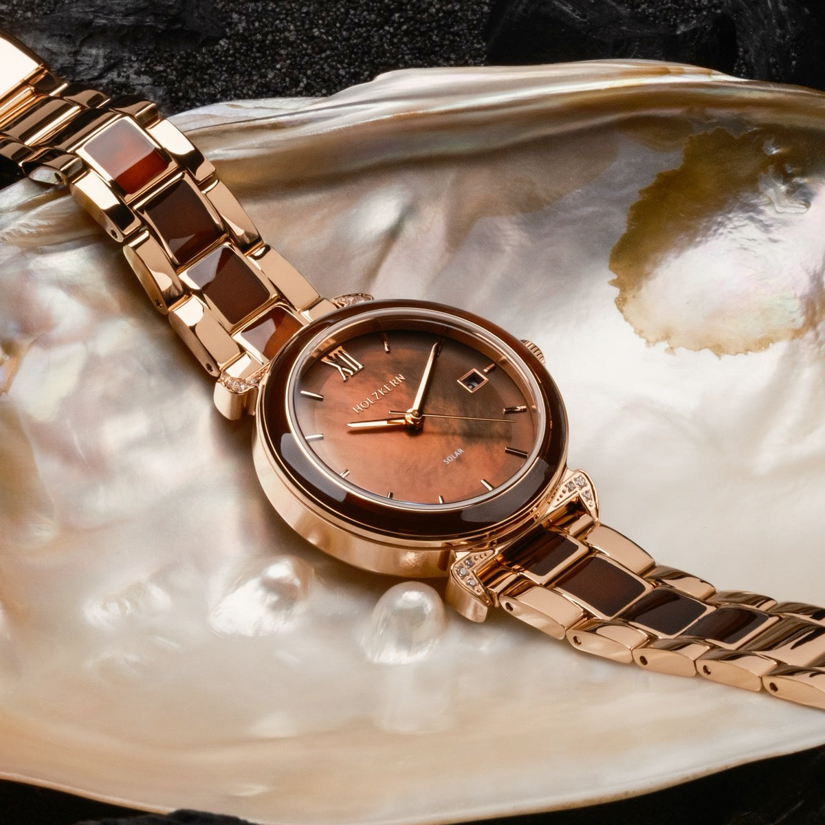 "Sunglister", wristwatch, featuring a brown mother-of-pearl dial and rose gold accents in an elegant design.