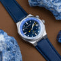 "GMT Cloudhopper" watch with a marble and blue design, featuring a distinctive GMT style and leather strap.