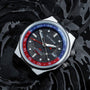 "GMT Cloudhopper" watch with a marble/black face and vibrant colors, featuring a GMT design on a stylish backdrop.
