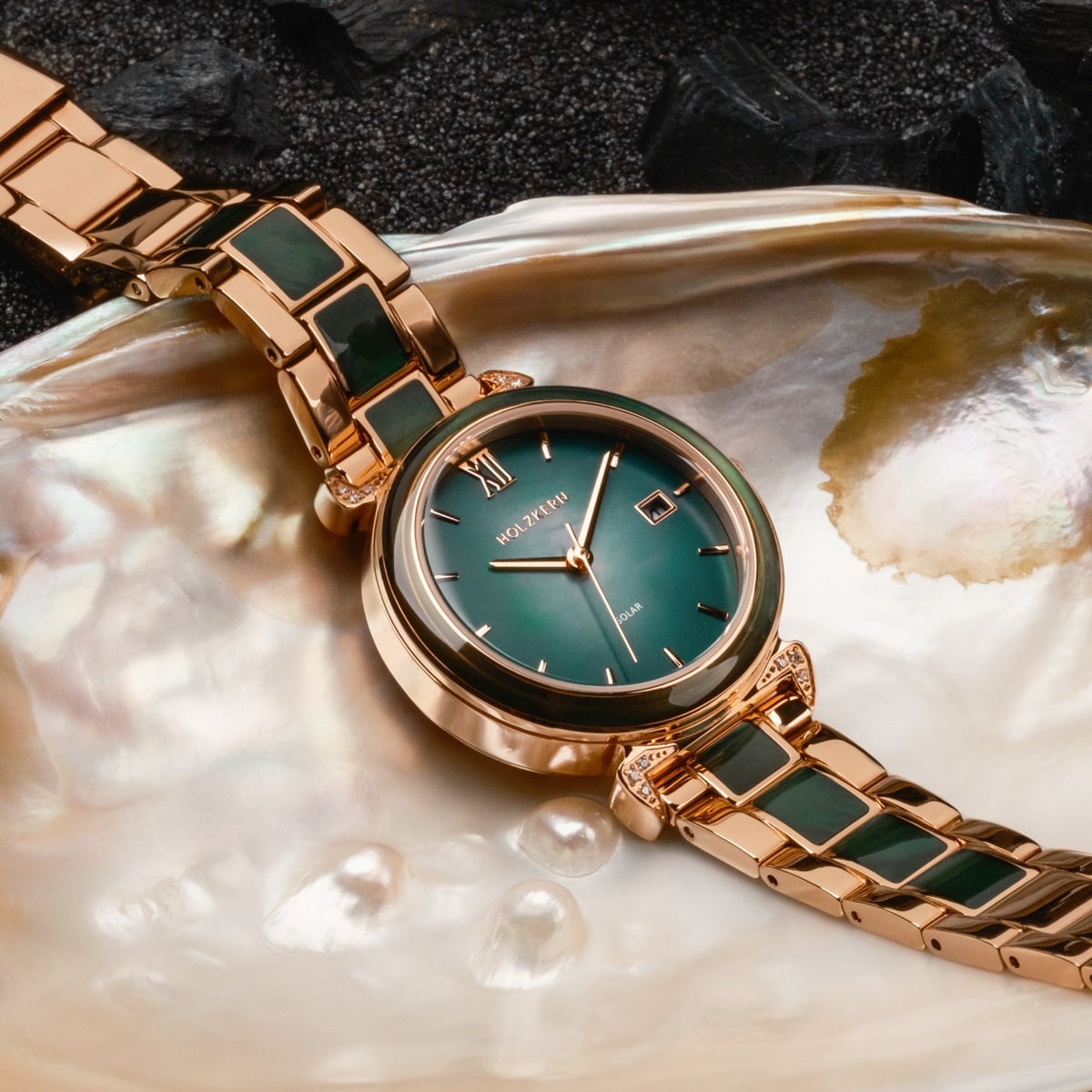 "Sunglister" watch with a green mother-of-pearl face and rose gold band, showcasing elegant craftsmanship.
