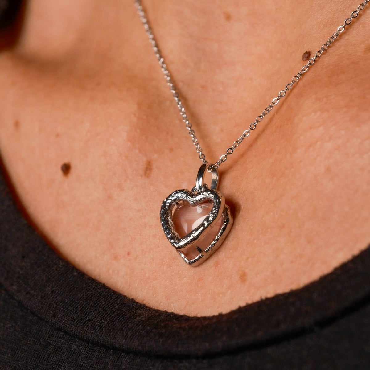 "Amorance Necklace", a heart-shaped quartz and silver necklace with a delicate chain, showcasing modern elegance.