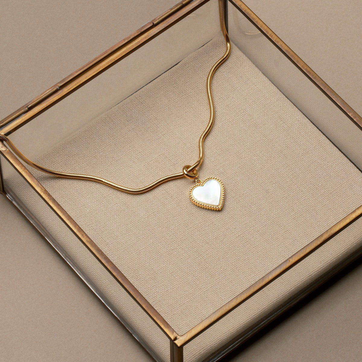 "Amorance Necklace" necklace featuring a heart pendant with nacre and gold design in an elegant display box.