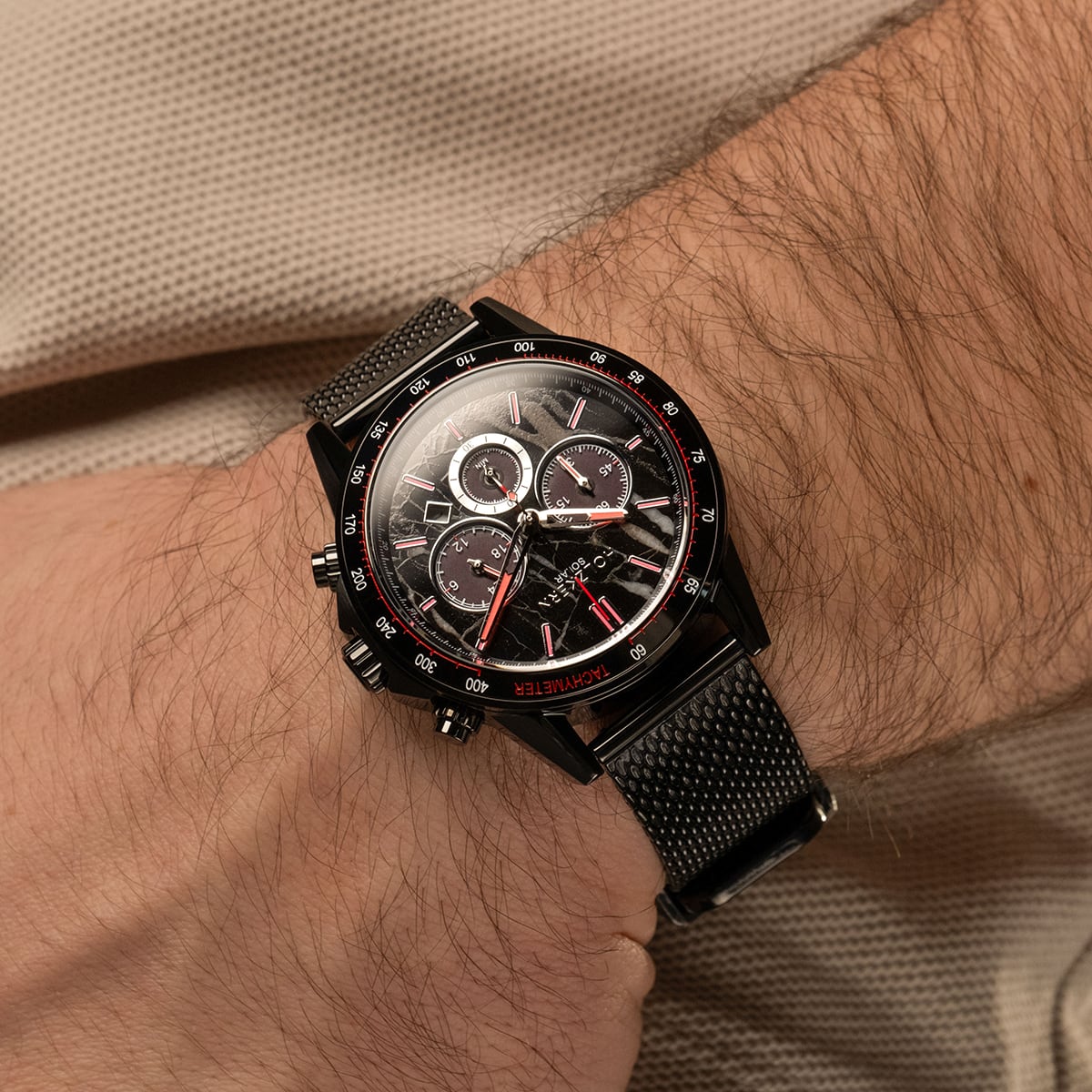 "Comfort Crusher", a sleek wristwatch featuring a marble face design and black tones, worn on wrist.