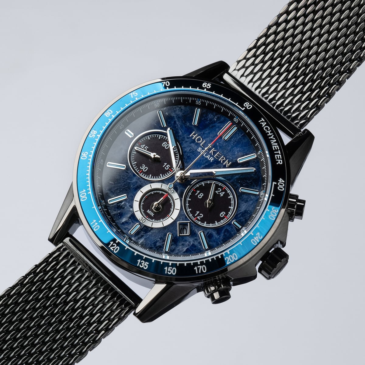 "Comfort Crusher" watch featuring a sodalite dial and dark gray mesh strap for a sleek and sophisticated style.
