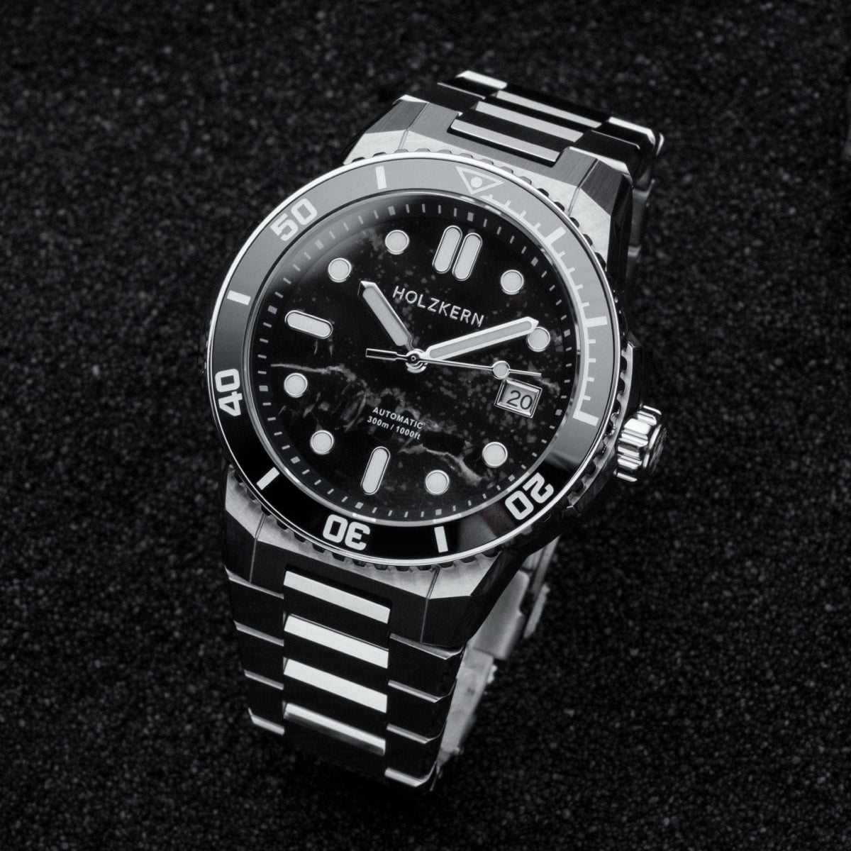 "Deepdiver" watch featuring a sleek marble and silver design with a durable strap.