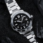 "Deepdiver" watch in marble and silver, featuring a sleek, sporty design with a textured black dial and metallic bracelet.