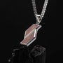 "Baritone Necklaces": a sleek geometric necklace in walnut and silver.
