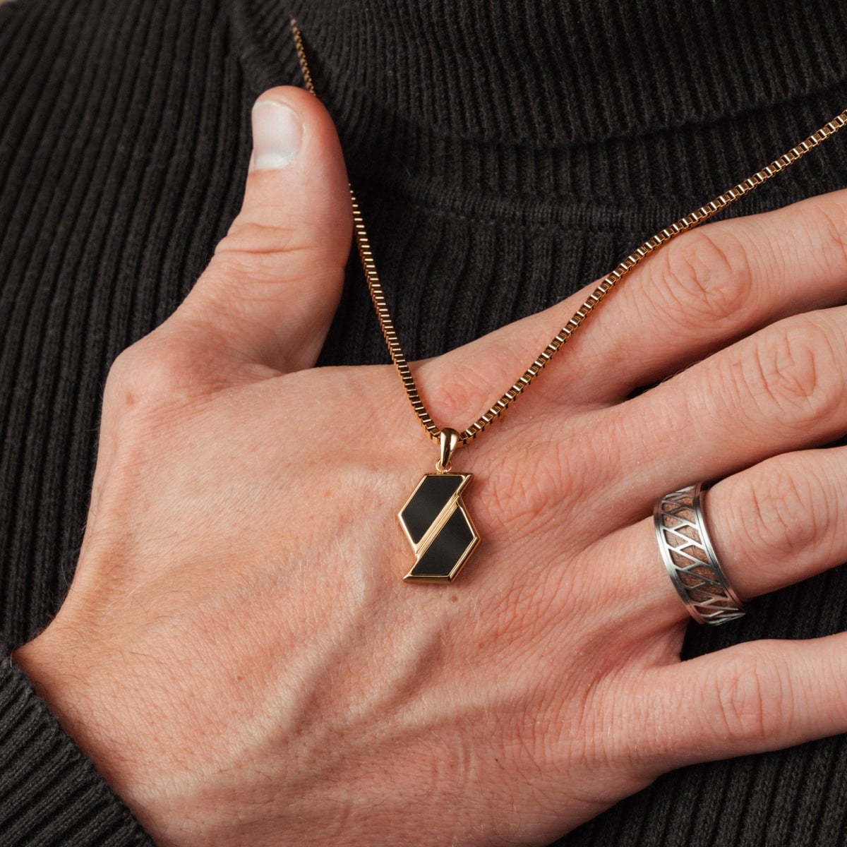 "Baritone Necklaces" necklace in marble and gold, featuring a modern geometric pendant design.