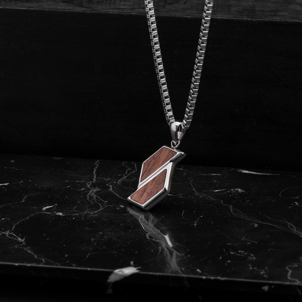 "Baritone Necklaces" necklace featuring walnut and silver design with a sleek, modern aesthetic.