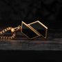 "Baritone Necklaces", a modern necklace featuring a marble and gold geometric design on a chain, displayed on a dark background.