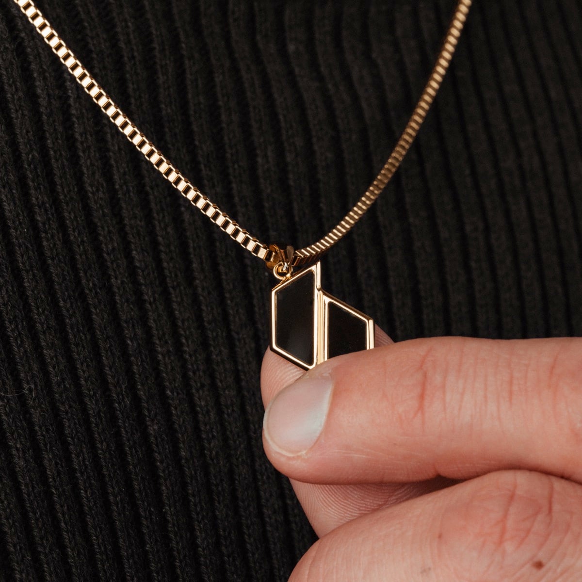 "Baritone Necklaces", a necklace featuring marble and gold, with a modern, geometric design.